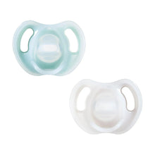 Two silicone baby soothers, light blue and white, symmetrical orthodontic design