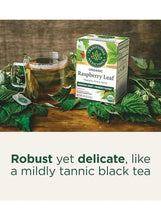 Organic raspberry leaf herbal tea box with cup of tea and tea leaves on wood