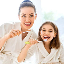 Mini folding travel toothbrushes in use, two people brushing with small soft bristles