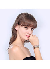 Huitich triple tone crystal bracelets set worn on wrist by woman with light brown hair and black top