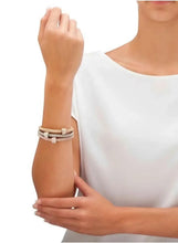 Triple tone crystal bracelets on wrist with stacked beaded chain links, rose and silver