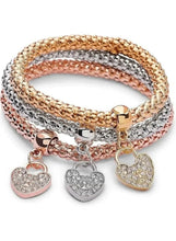 Triple-tone charm bracelet set with three beaded bangles and five heart pendants, rose gold