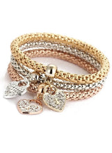 Triple-tone heart charm bracelets with three beaded bands, gold toggle clasp, and crystal hearts