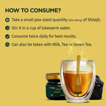 Shilajit resin jar, small spoon, and glass cup with amber drink
