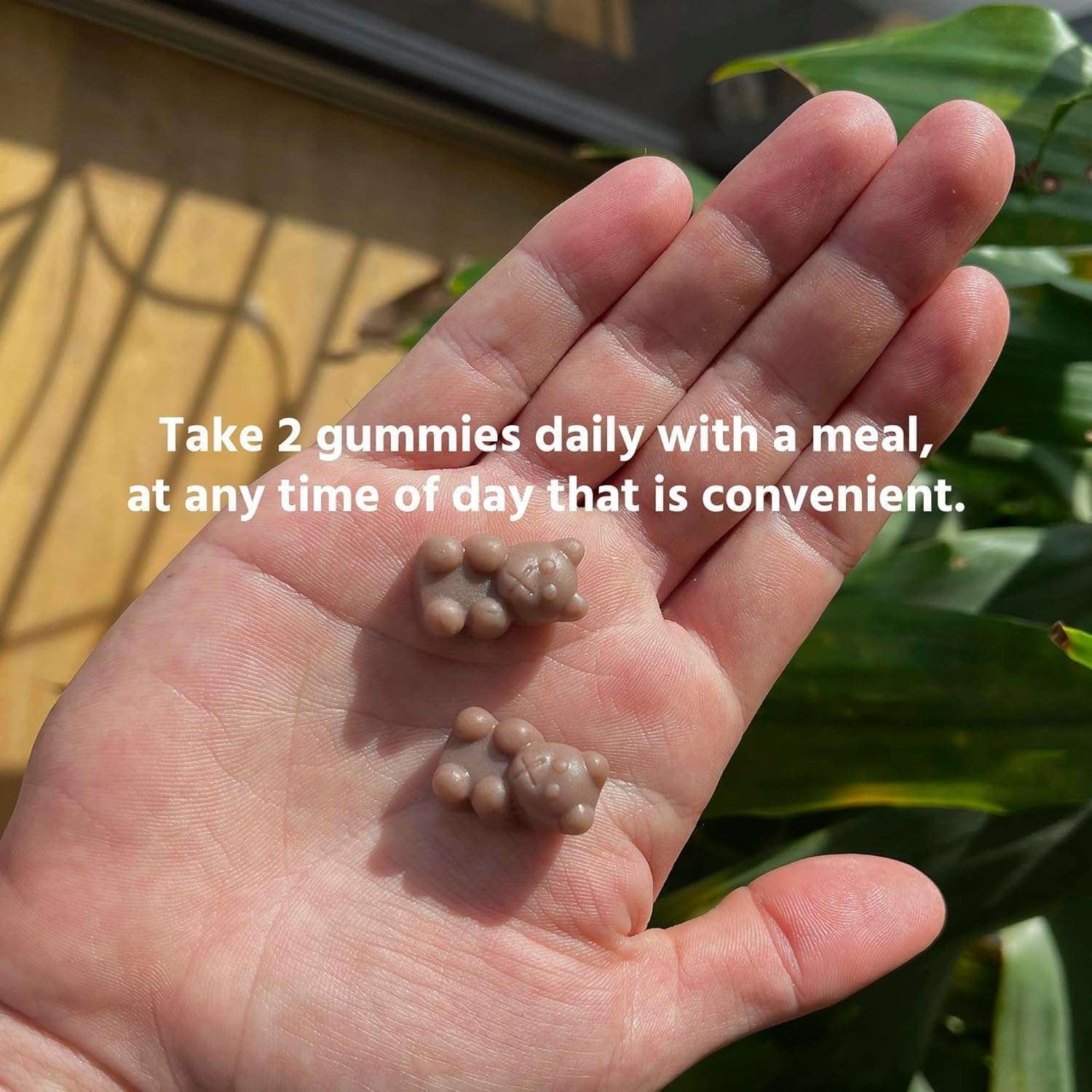 TruHeight height growth gummies for kids two brown bear gummies in an open palm with dosing instructions overlay