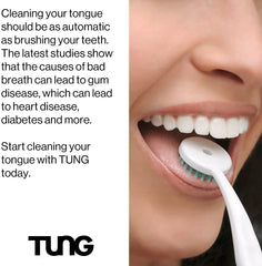Close up of smiling person using a white TUNG tongue cleaner brush with green bristles on tongue