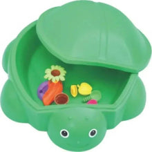 Green turtle sandbox with raised dome lid and colorful toys inside
