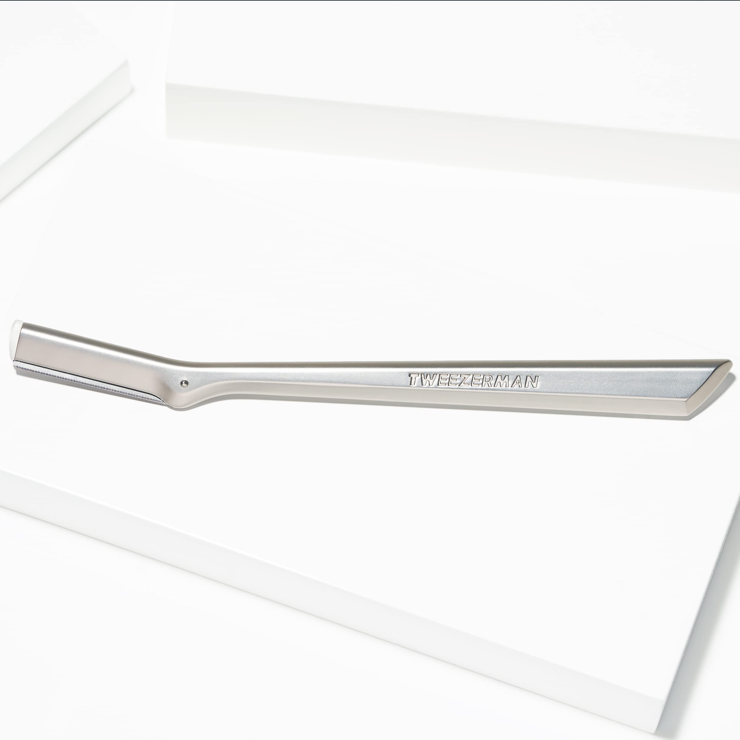Tweezerman facial razor for women stainless steel eyebrow razor with slim ergonomic handle on white background