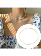 Faux pearl choker necklace with evenly spaced pearl beads and gold clasp