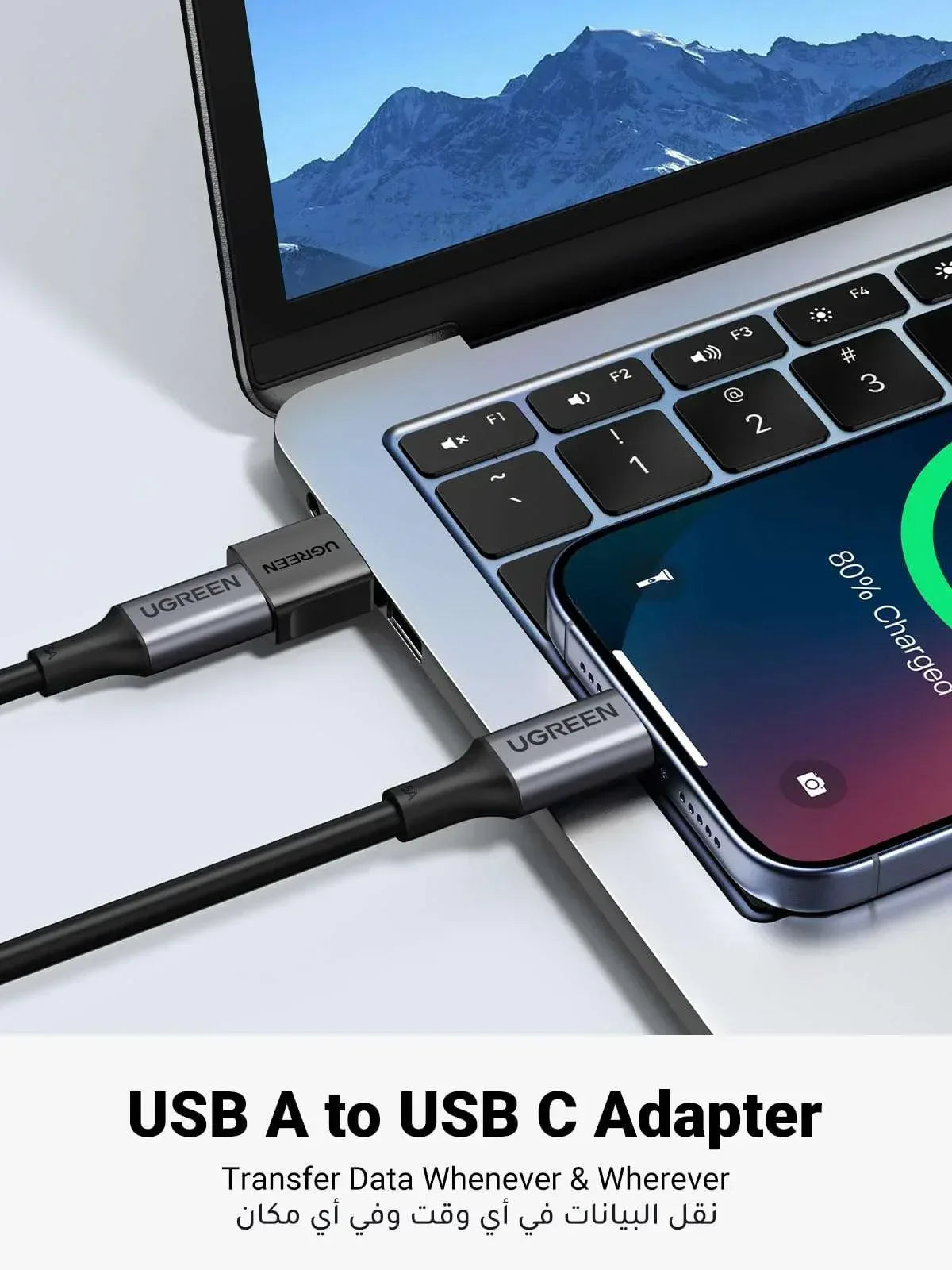 USB Type-C to USB-A adapter with black connectors connected to laptop and smartphone