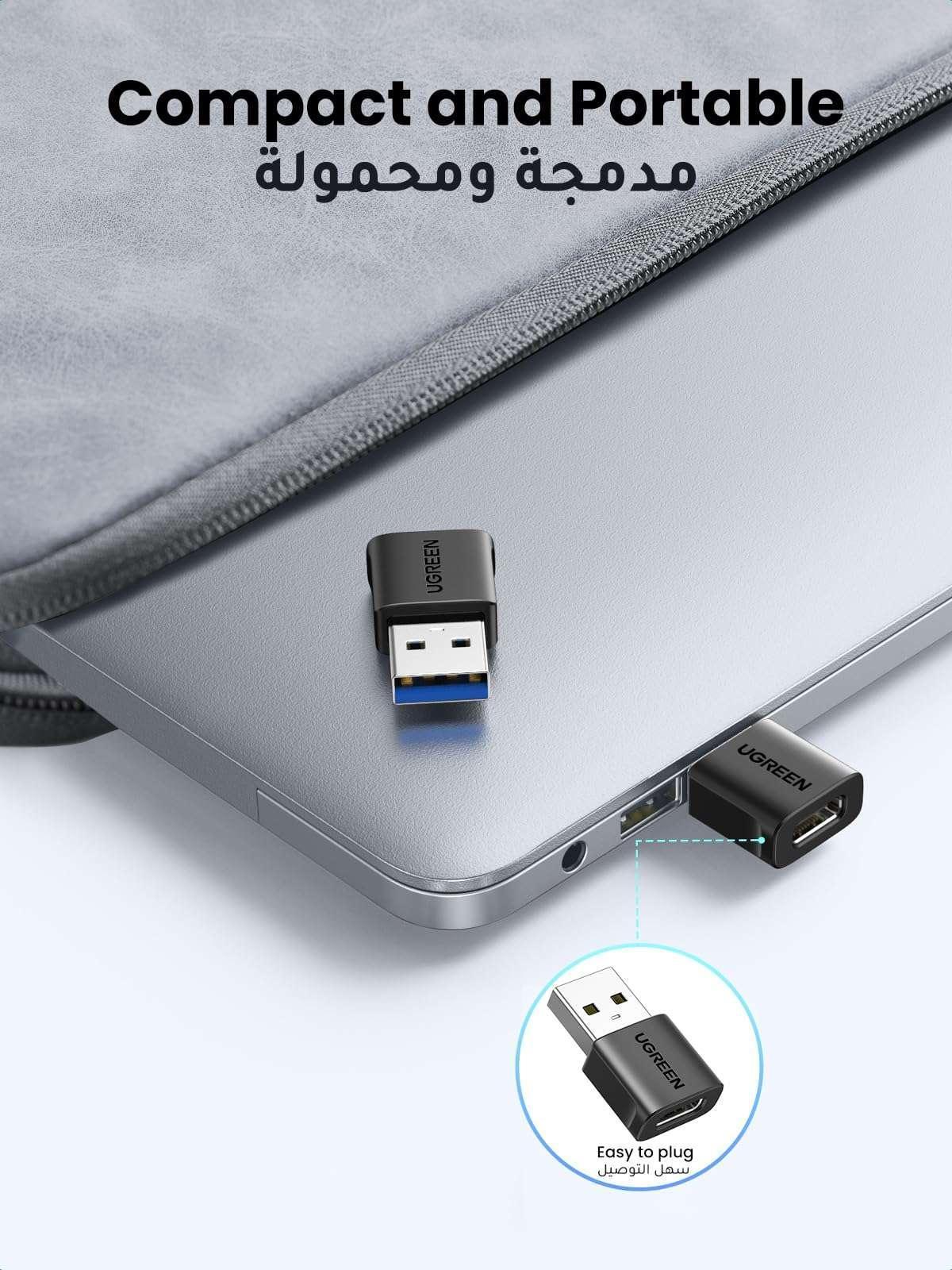 USB Type-C to USB-A adapter with black housing and USB-A connector, UGREEN on laptop