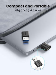 USB Type-C to USB-A adapter with black housing and USB-A connector, UGREEN on laptop