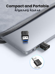 10Gbps Type C to A Connector by UGREEN plugged into a laptop USB port showing compact and portable design