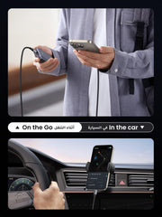 Person using a fast charging USB C to Type C cable to charge a phone in a car