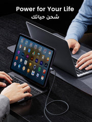 USB-C to Type C cable for iPhone 16 Pro Max charging a tablet with laptops on a dark desk
