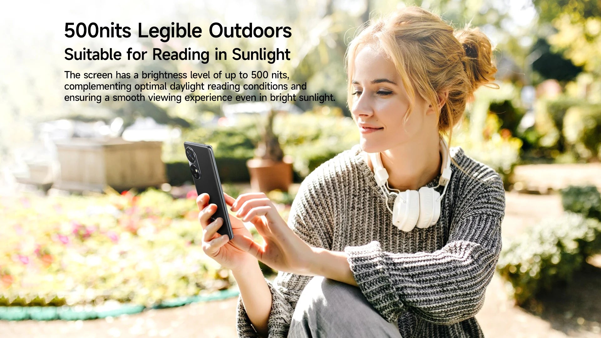 Young woman using Ulefone Note 17 Pro smartphone outdoors on a sunny day with headphones around her neck