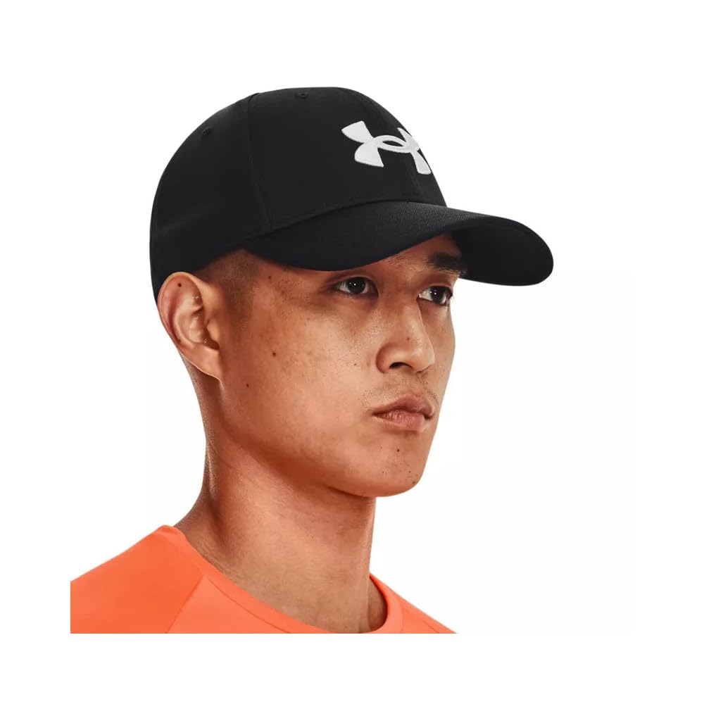 Black Under Armour Blitzing adjustable sports hat worn by man with curved brim and logo