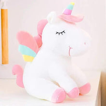 White unicorn plush lying down, rainbow horn, striped wings, embroidered eyes and face