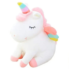 White unicorn plush with rainbow horn, striped mane, and embroidered closed eyes