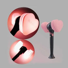 Decorative party light with black stand and pink heart-shaped bulbs, glowing outward