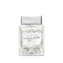 Clear musk perfume bottle with ornate label and open silver cap