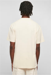 Back view of a man wearing an Urban Classics tall tee for men in beige with short sleeves