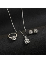 Silver-tone 3-piece jewelry set closeup: ring, pendant necklace, and square stud earrings