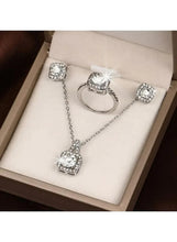 Silver-tone 3-piece jewelry set on tray: ring, stud earrings, and pendant necklace