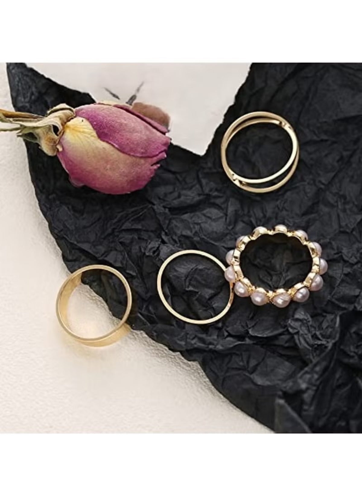 Huitich 4-piece gold ring set online with pearl and plain designs displayed on black fabric