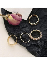Gold ring set with pearls: three gold bands and one pearl cluster ring