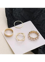Gold and silver-tone ring set on card: two gold bands, one silver band, pearl ring