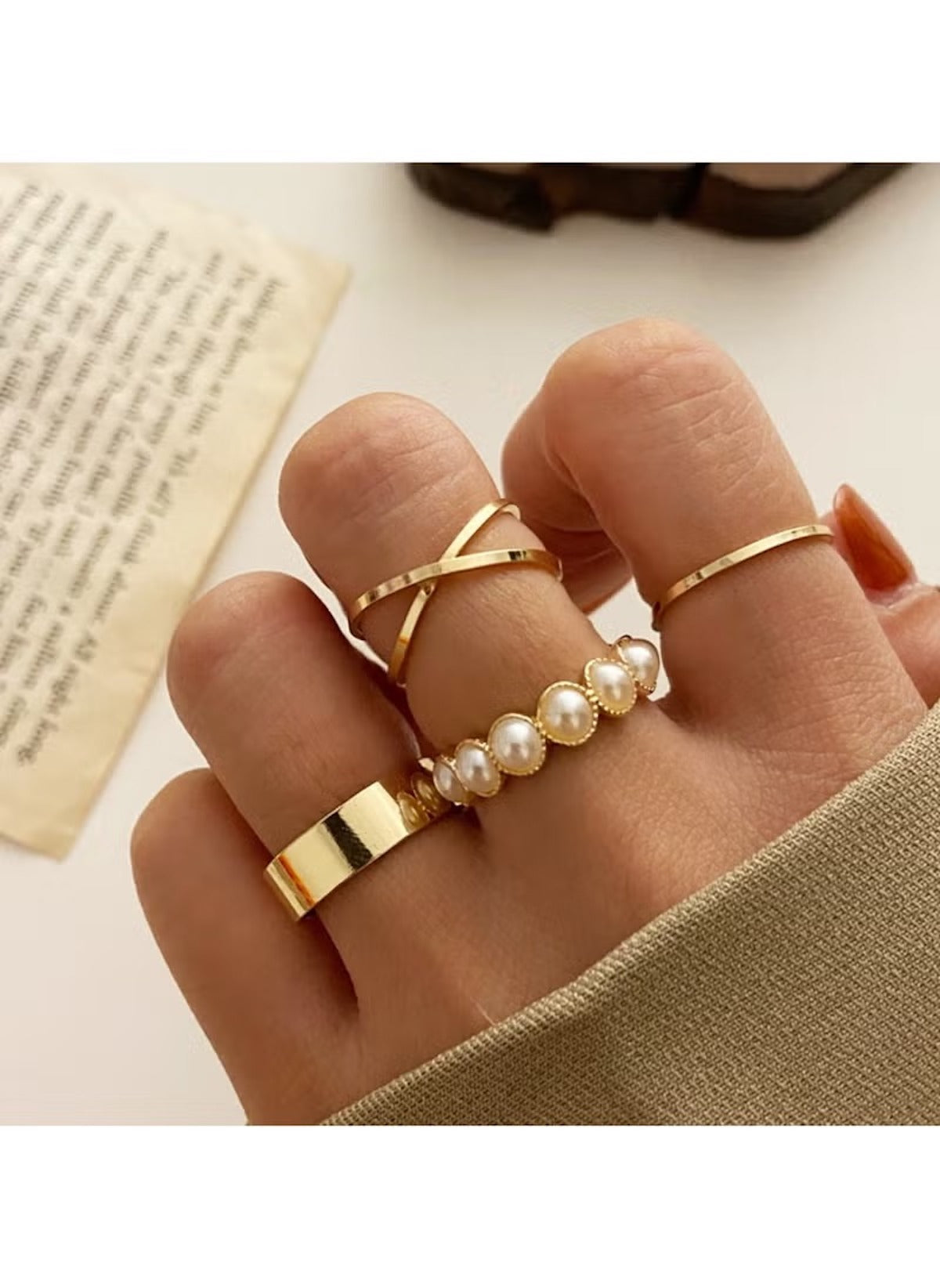 4-piece gold ring set online featuring minimalist gold bands and pearl accents on fingers