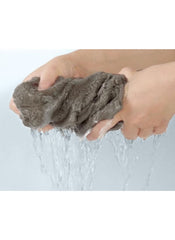 Huitich gray towel being squeezed with water flowing out showing absorbency in 8 piece towel set online