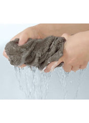 Hands wringing out a soft gray towel from Huitich 8 piece towel set online showing absorbency
