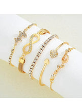 Gold crystal charm bracelets in mixed styles with heart, cross, and bangle cuffs