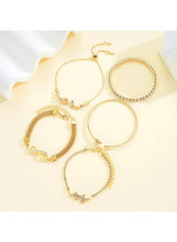 Gold adjustable bracelet set with round bangles, crystal accents, and small charm pendants