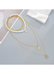 Huitich layered chunky chain and faux pearl necklace with gold pendants on gray background