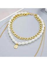 Chunky gold chain and faux pearl necklace set with oval charm and layered strands