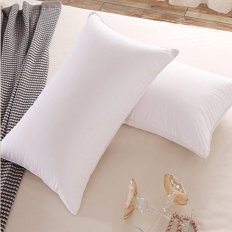 Huitich white cotton bed pillows UAE on beige bed with textured black and white blanket