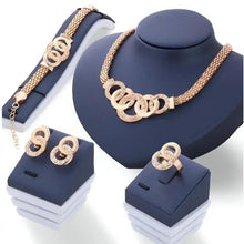 Gold-tone pendant necklace with linked O-style centerpiece and chain, with matching earrings