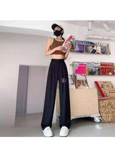 Black wide-leg office pants with relaxed fit and elastic waistband