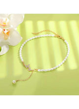 Pearl butterfly necklace with gold chain, crystal butterfly, and dangling pearl drop
