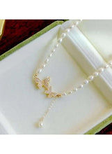 Pearl and gold butterfly necklace with crystal wing charms and dangling pearl strand