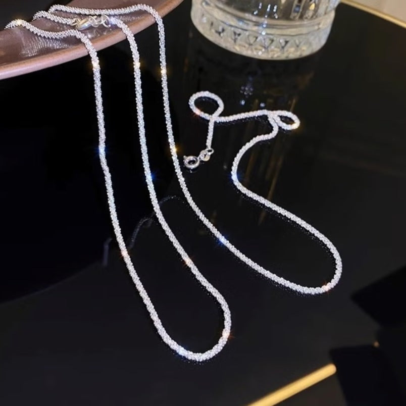 Huitich silver layered choker necklace with delicate shimmering chain displayed on black reflective surface