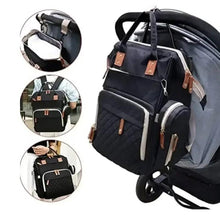 Black changing backpack on stroller with side bottle pocket and tan leather-look accents