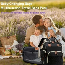 Black baby changing backpack with quilted front panel, white trim, and tan leather-look accents