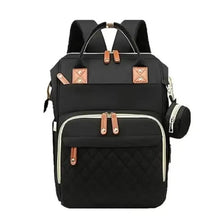 Black baby changing backpack with quilted front panel and tan leather-look accents