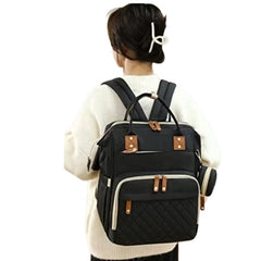 Huitich waterproof baby changing backpack in black worn by a woman for travel and convenience