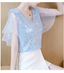 Lovely women's sequin chiffon blouse in light blue with elegant flutter sleeves