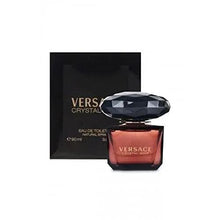 Perfume set with small dark maroon bottle and matching box, faceted black cap